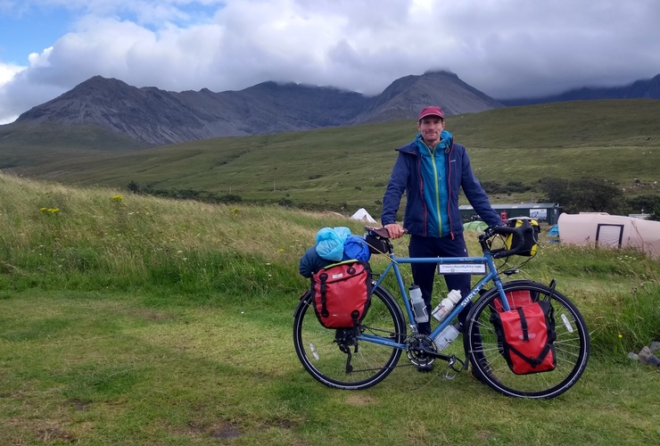 Oli Warlow and his bike, against a backdrop of the Cuillin Ridge