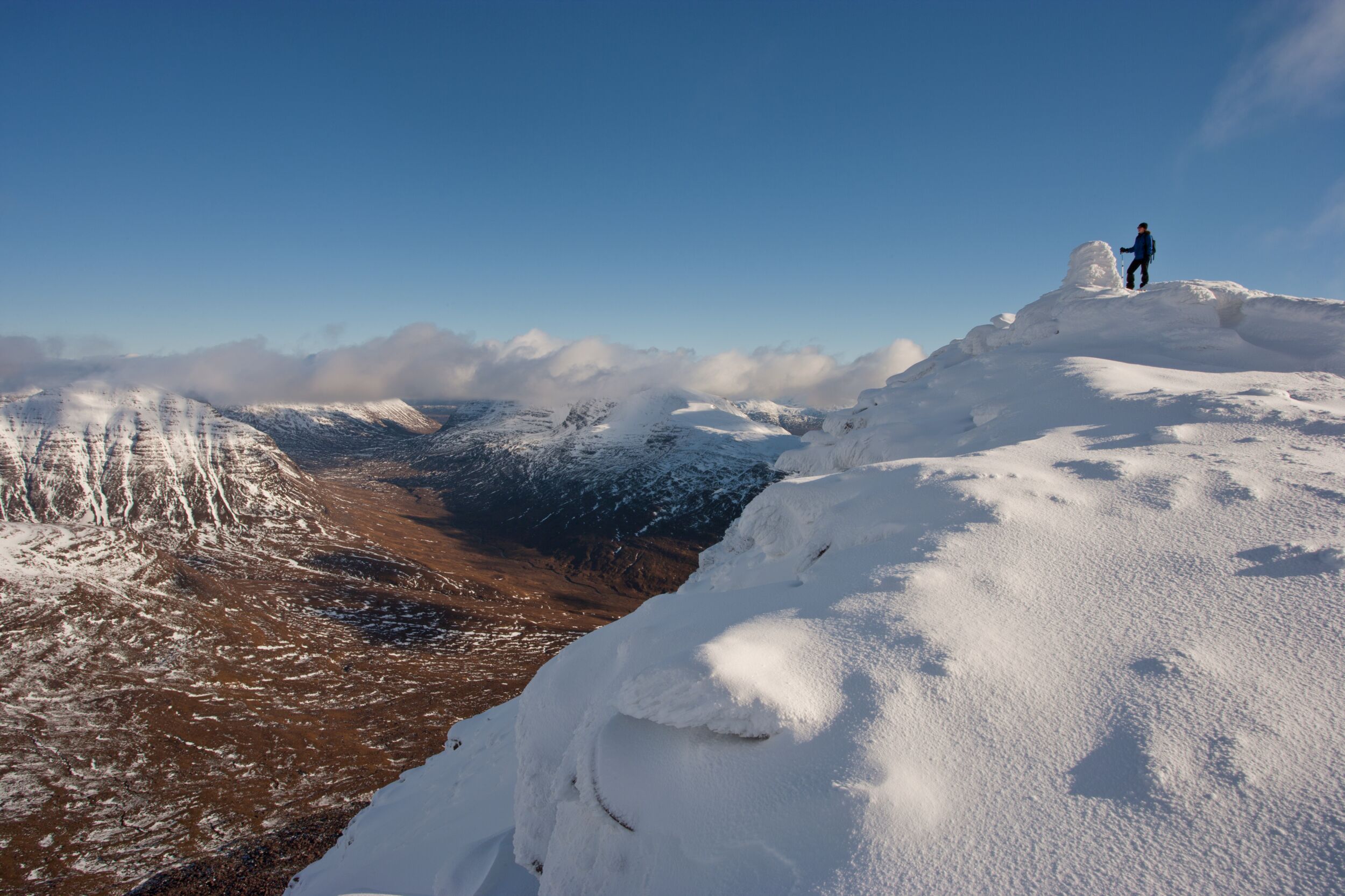 Hill walker on the summit of Tom na Gruagaich (922m) in winter, Beinn Alligin, Torridon, Scotland &copy; Mark Hamblin / 2020Vision